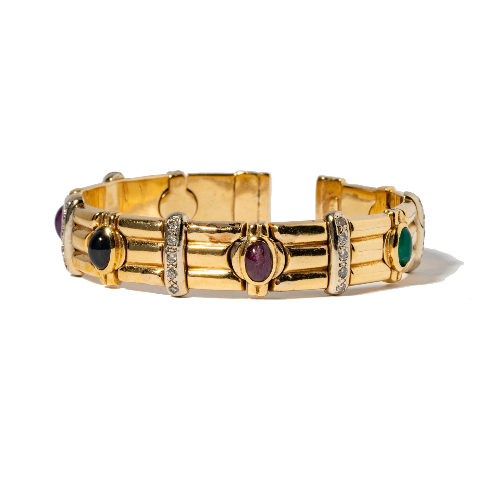 14 Karat Yellow Gold, Multi-Stone, and Diamond Bangle Bracelet: Including one 14 karat yellow gold diamond gem-set cuff; set with amethyst, ruby, onyx and emerald, and accented with 25 small round full-cut diamonds weighing approximately 0.35 carats; cuff measurin