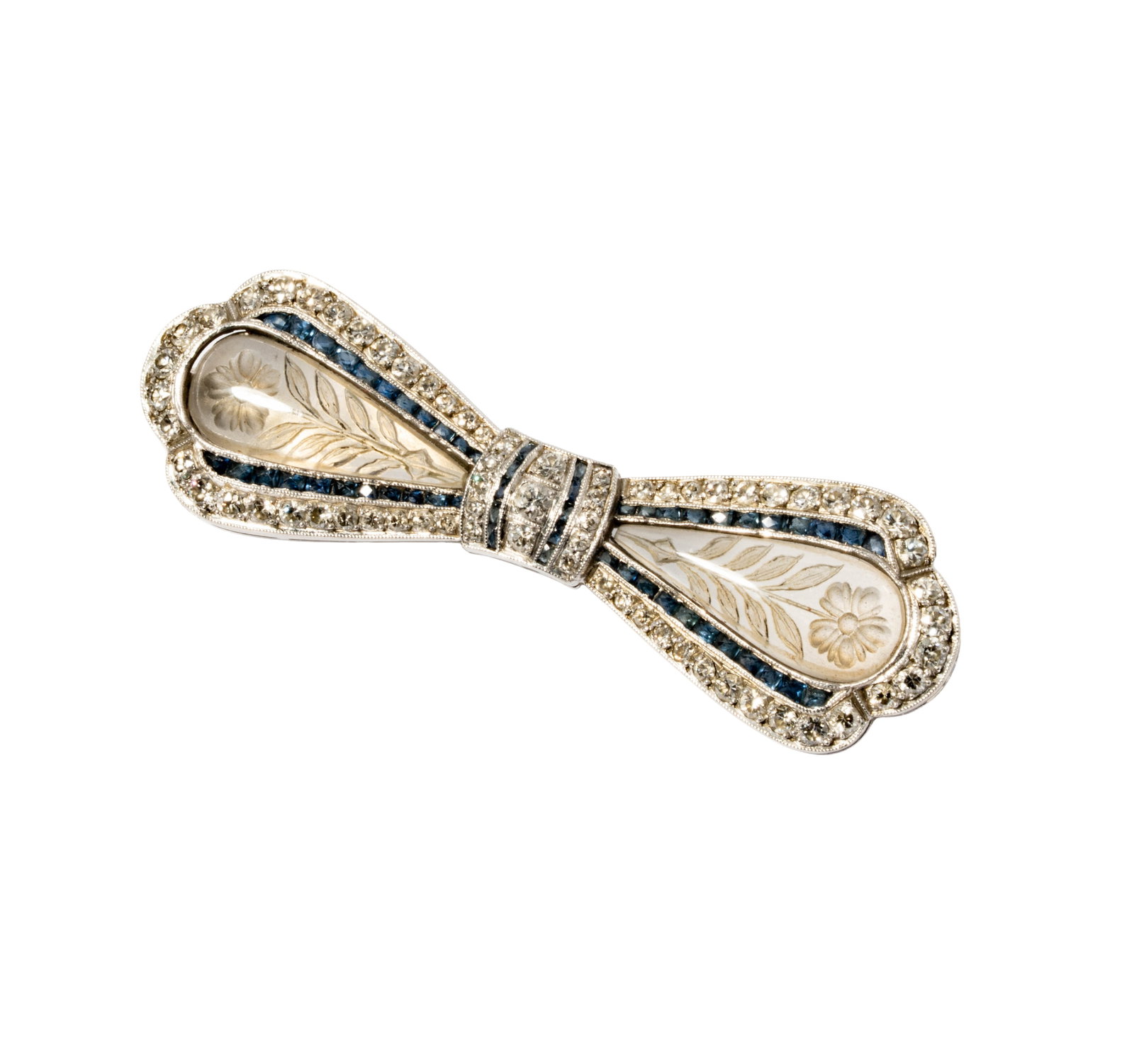 Platinum, 14 Karat White Gold, Diamond, Rock Crystal and Sapphire Bow Brooch: Including one 14 karat white gold platinum, diamond, sapphire and rock crystal bow brooch; set with 67 small round full-cut diamonds [H-J/SI] weighing approximately 1.50 carats total, and accented wit