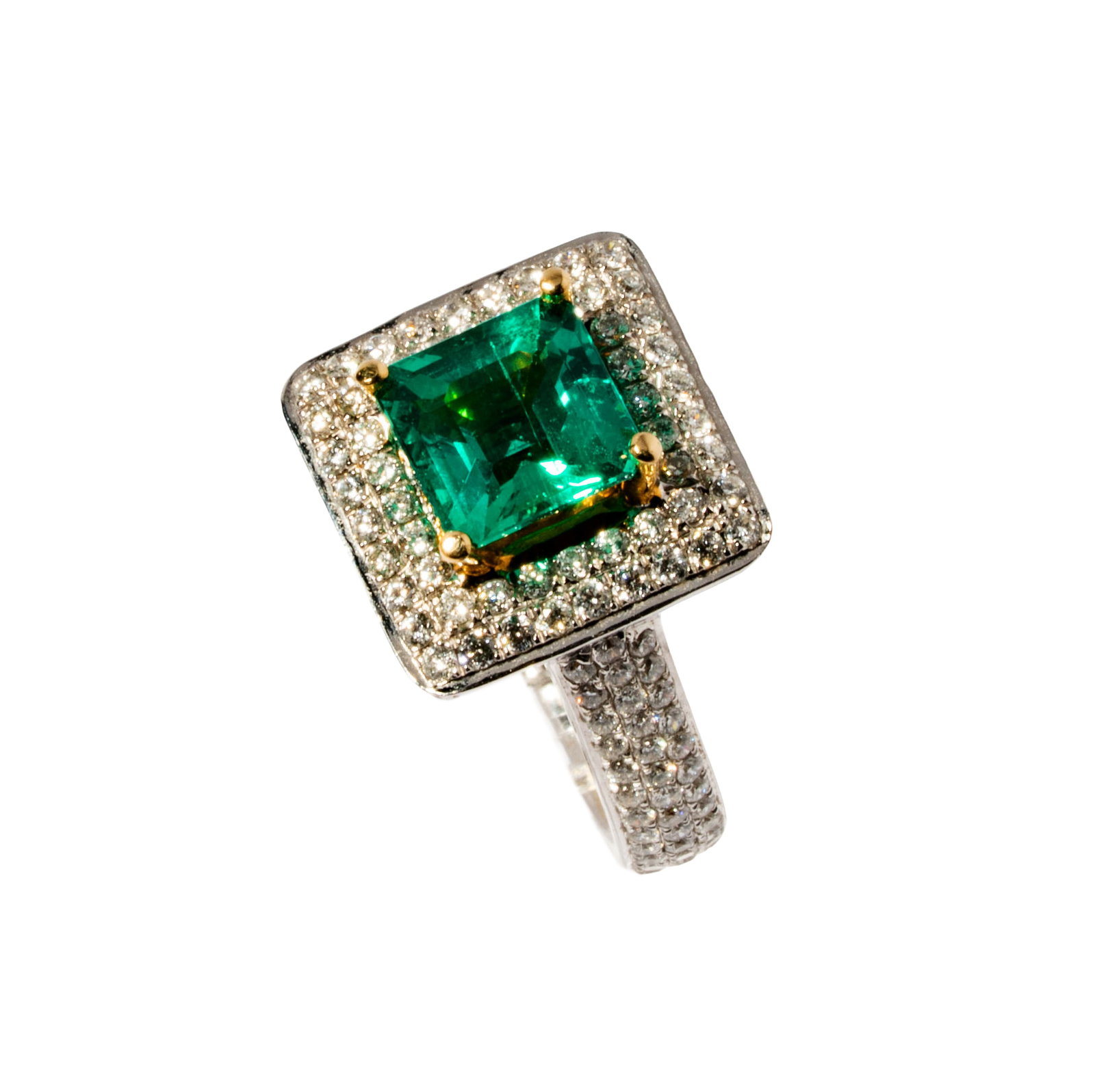 14 Karat Yellow, White Gold Emerald and Diamond Ring: Including one 14 karat yellow and white gold diamond and emerald ring, set with one square step cut emerald weighing approximately 2.20 carats, and accented with 151 small round diamonds [G-I/Si], wei