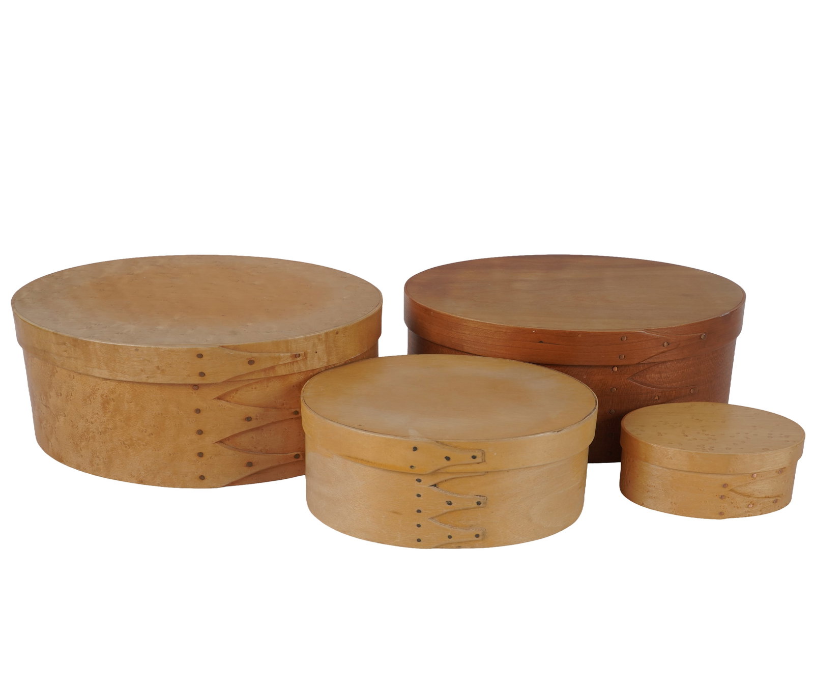 Four Vintage American Bentwood Shaker Boxes: each stamped to underside, smallest: 1 3/4 x 4 1/2 x 3 in., largest: 4 x 10 x 7 in.