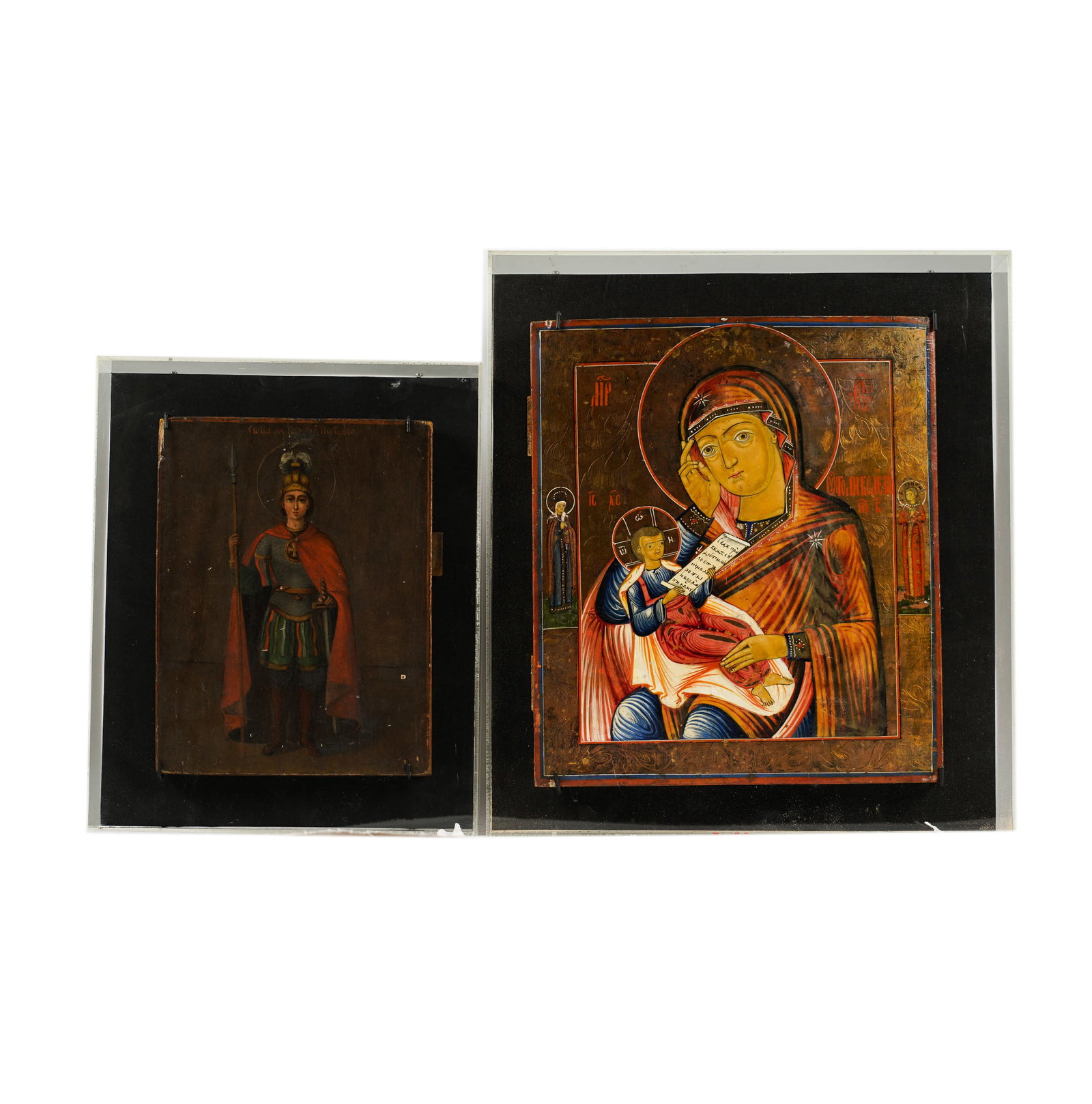Two Russian Icons: in acyrlic cases, largest frame: 17 1/4 x 15 1/2 in., smaller frame: 14 x 11 1/2 in. larger: 14 x 12 1/2 in. (35.6 x 31.8 cm.), smaller: 10 1/2 x 8 in. (26.7 x 20.3 cm.)