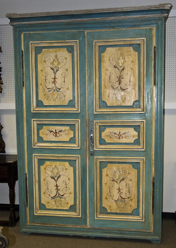 CONTINENTAL PAINTED ARMOIRE: the molded cornice above a pair of larger painted and paneled doors 68 3/4 inches wide; 26 1/2 inches deep; 100 inches high
