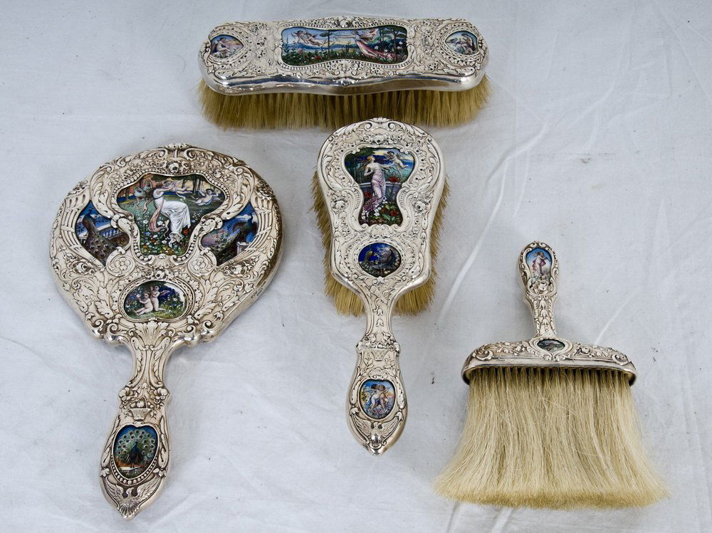 GORHAM STERLING & ENAMEL FOUR-PIECE DRESSER SET: comprising of three brushes and a hand mirror each with Neoclassic enameled plaques Provenance: Estate of David Copley, La Jolla