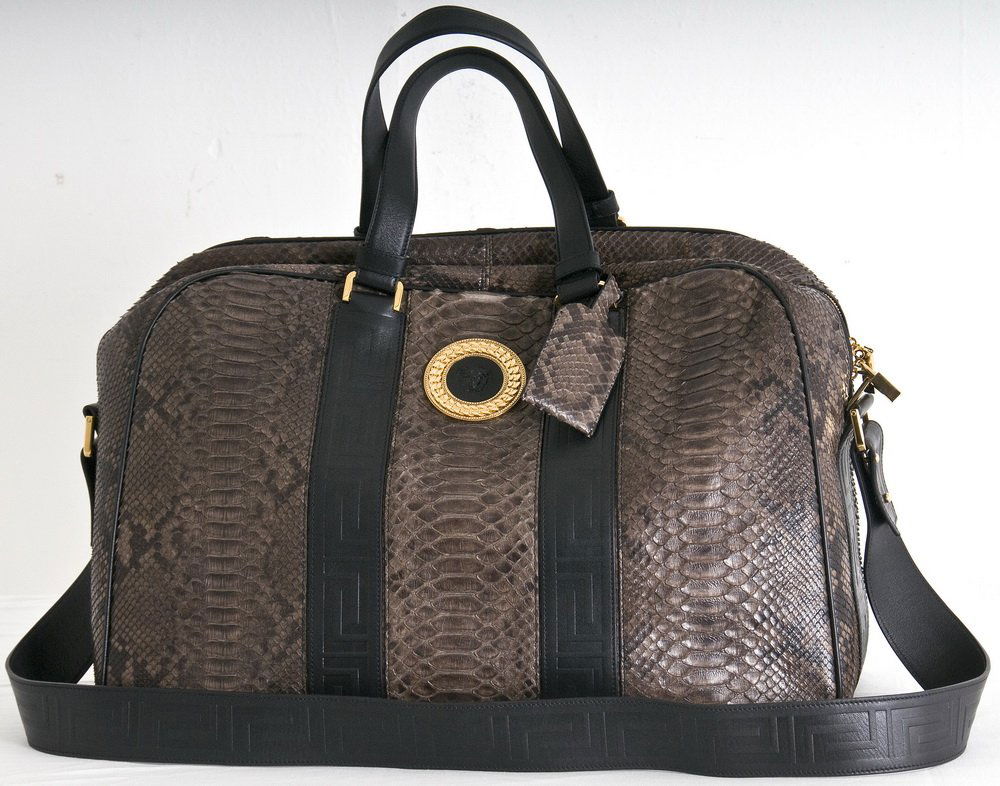 VERSACE REPTILE AND LEATHER WEEKENDER: Gianni Versace boutique black and grey snakeskin; zippered soft suitcase; gold tone hardware; two top handles and embossed leather shoulder strap 20 inches wide; 8 inches deep; 13 inches high