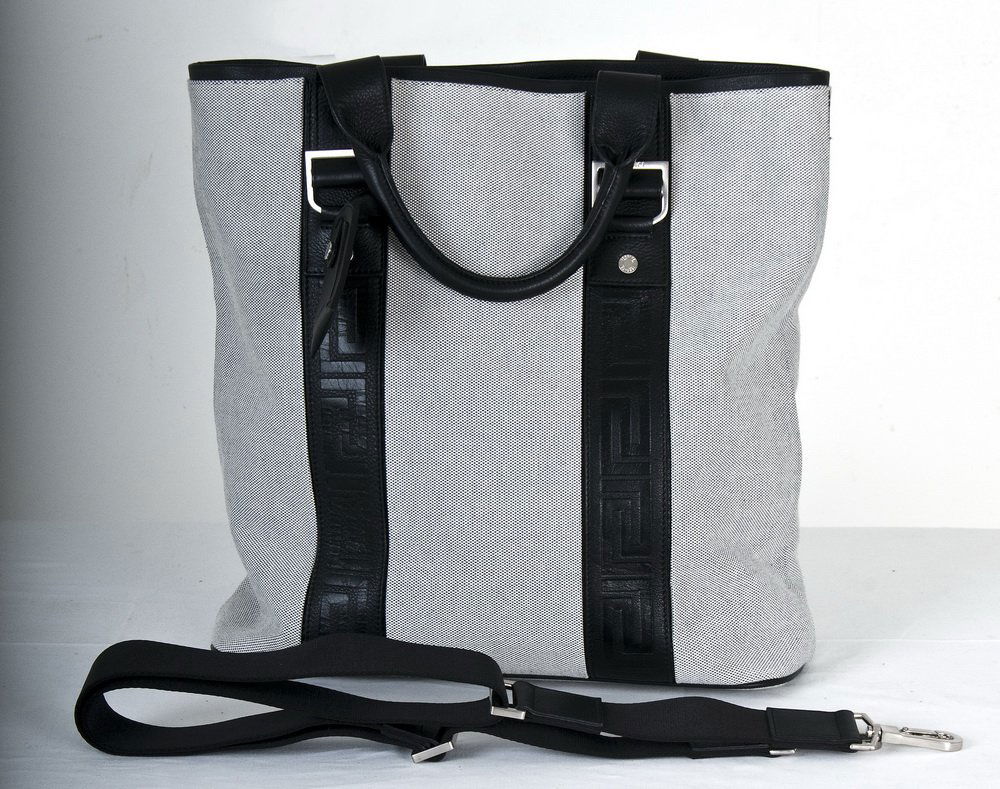 VERSACE LEATHER & CANVAS TOTE BAG: black and white cotton; twin black leather handles; metal hardware; black leather signature; identification tag 16 inches wide; 6 inches deep; 14 inches high