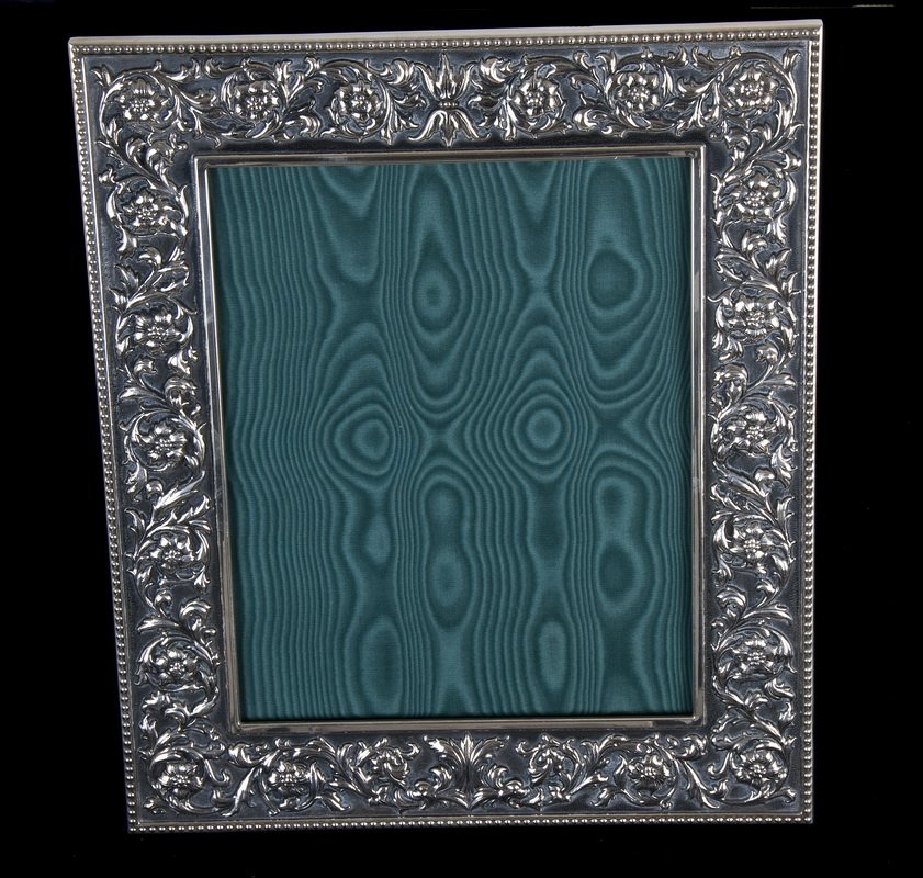 BUCCELLATI LARGE STERLING FRAME: Medicea pattern; leather backing with sterling silver closure rosettes; marked "Buccellati Italy;" for 8 x 10 photo Condition: missing glass 11 1/2 inches wide; 13 1/2 inches high