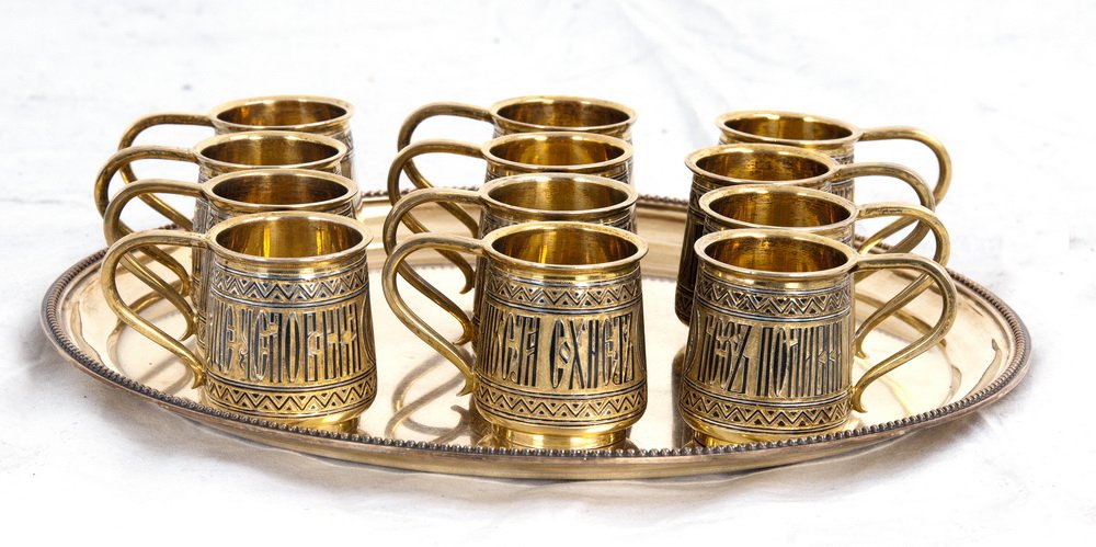 RUSSIAN GILT SILVER DEMITASSE SET: circa 1880; marked AK, St. Petersburg comprising of twelve cups and a tray the tray measuring 8 3/4 inches diameter