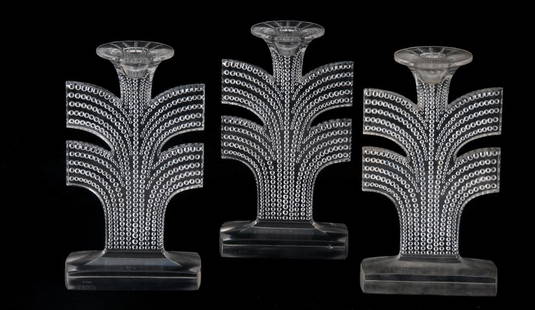 THREE RENE LALIQUE MOLDED CRYSTAL CANDLESTICKS: Tokyo pattern each inscribed "R. Lalique France" on front of base Provenance: The Estate of Dr. Herbert & Mrs. Rita LeRoy Roedling, a William "Billy" Haines commission 8 1/4 inches high