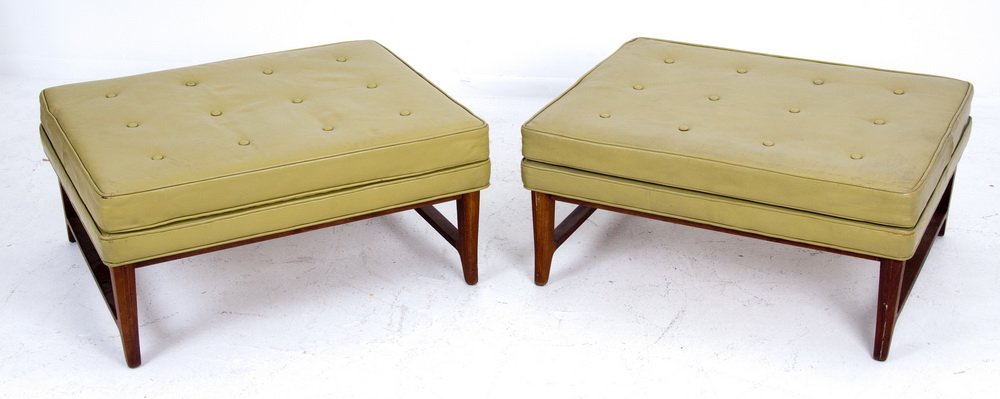 PAIR OF DUNBAR WALNUT FRAMED OTTOMANS: designed by Edward Wormley for Dunbar with green vinyl seat Provenance: The Estate of Remy L. Chatain, Jr., Pasadena 32 inches wide; 27 inches deep; 15 inches high