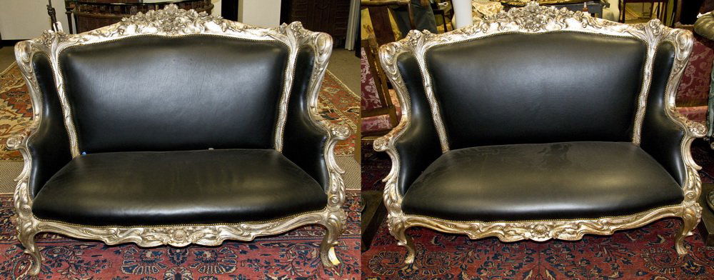 PAIR OF CONTINENTAL CARVED & SILVER GILT SETTEES: each with a carved foliate high back, arms, and supports with black studded leather upholstery 57 inches long; 41 inches high