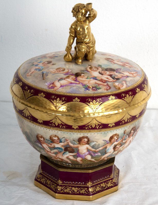 KPM PORCELAIN COVERED BOWL: the lid with a cherub finial and painted cherub surround; the bowl marked Royal Berlin; on an octagonal stand marked Perkenhamer 11 inches diameter; 15 inches high