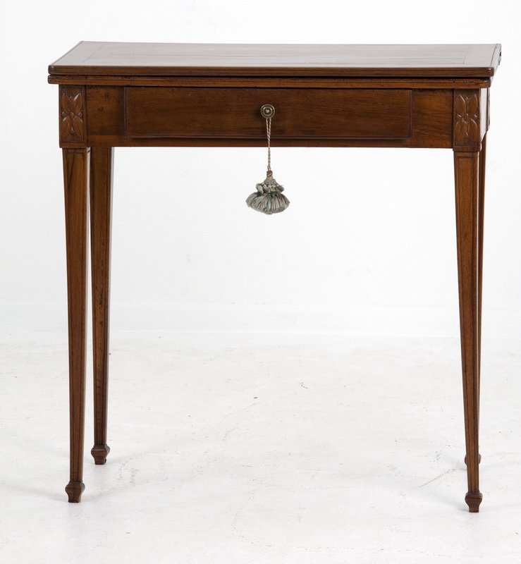 ITALIAN NEOCLASSICAL WALNUT GAMES TABLE: the hinged rectangular top above a single frieze drawer, tapered square supports and a gate leg support 30 inches square (open); 31 inches high