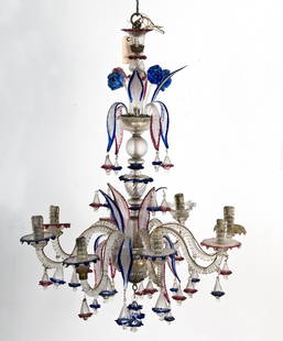 VENETIAN COLORED CRYSAL EIGHT LIGHT CHANDELIER: the molded stem with scrolled arms and blown glass flowers, leaves, and bell form drops Provenance: The Estate of Dr. Herbert & Mrs. Rita LeRoy Roedling, a William "Billy" Haines commission 32 inches