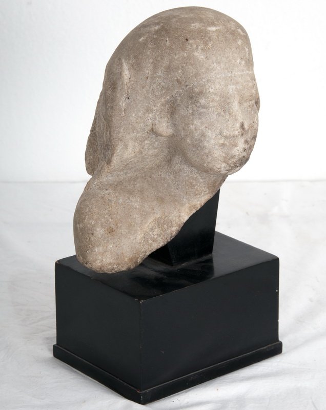 EGYPTIAN LATE DYNASTY LIMESTONE BUST: in the head of a Pharaoh, on a black painted base Provenance: The Estate of Remy L. Chatain, Jr., Pasadena 7 1/2 inches high