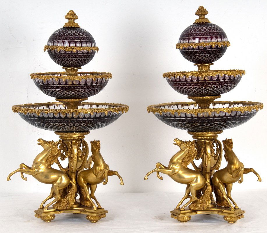 PAIR OF GILT BRONZE & CUT CRYSTAL EPERGNES: each having three tiers supported by a tripod base with stallions 17 inches diameter; 31 1/2 inches high