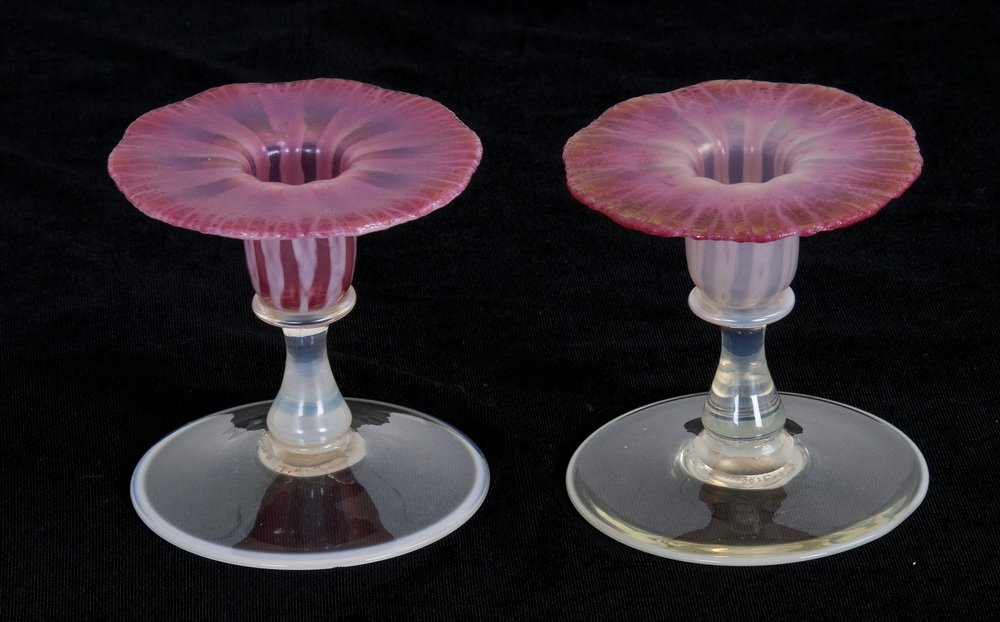 TIFFANY ROSE PASTEL CANDLESTICKS: each pink fluted candle cup on a narrow opalescent stem and wide round foot; one having maker's stamp and signed L.C.T. Favrile 1927 on underside; the other signed L.C. Tiffany Favrile 1927 3 3/4 inch