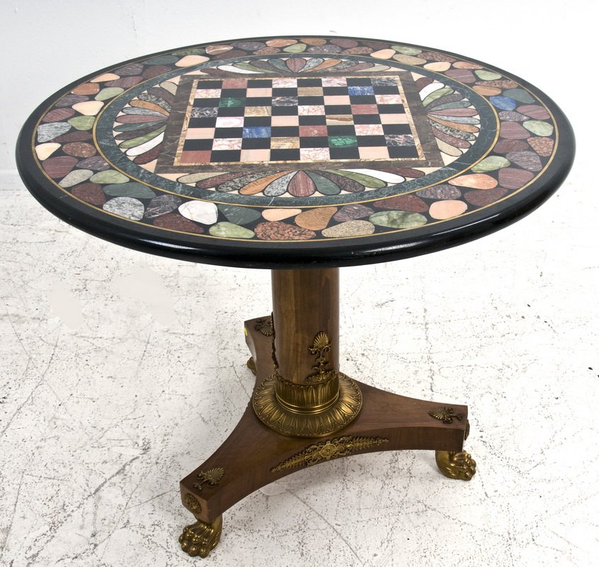 EMPIRE STYLE SPECIMEN MARBLE GUERIDON: the circular top inlaid with stone and brass bands and scallops around a stone checkerboard, on a gilt bronze mounted wood column support and tripartite base with gilt bronze claw feet 36 inches diame