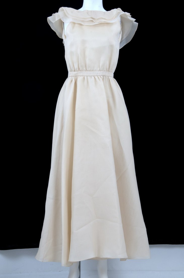 HALSTON BEIGE DRESS: Long wrap-around dress with three layers of beige silk taffeta; fitted waist and shawl collar 52 inches center back length; 24 inches waist