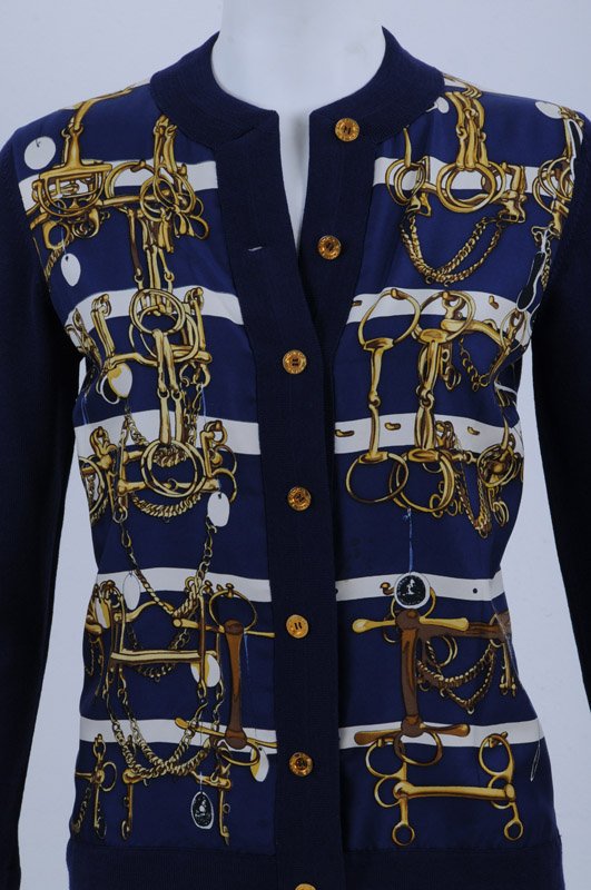 HERMES BLUE WOOL & SILK SWEATER: Vintage 100% wool cardigan with 100% silk scarf front featuring horse tackle and chains motif; ribbed cuffs; front button closure with signature buttons Size: 38; length: 24 inches