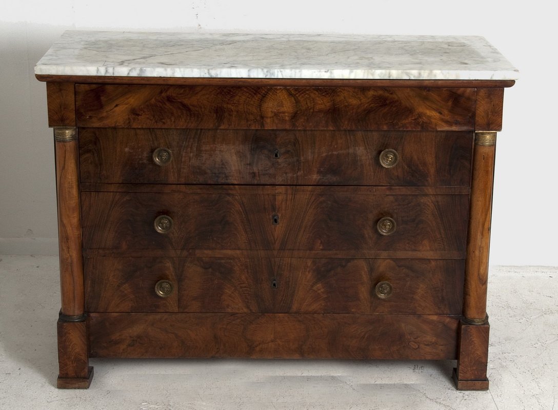 CHARLES X WALNUT CHEST OF DRAWERS: the rectangular white marble top above a single long frieze drawer and three long drawers flanked by columnar pilasters Condition: with chip to corner of marble top 50 1/2 inches wide; 22 inches deep;