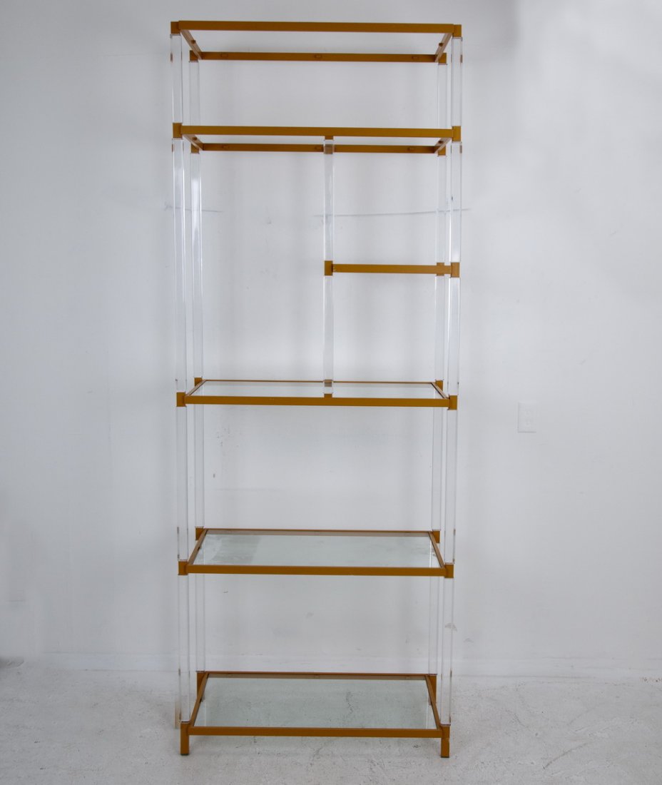 HUDSON-RISSMAN ACRYLIC & PAINTED METAL ETAGERE: possibly designed by Charles Hollis Jones the acrylic frame having five orange painted metal tiers and inset glass shelves 34 inches wide; 18 inches deep; 90 inches high
