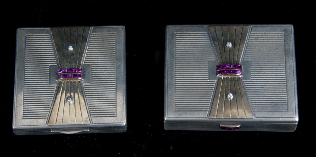 TWO ART DECO SILVER, GOLD, RUBY AND DIAMOND COMPACTS: 228 total grams the lid with bowtie decoration and ten rubies across the band with two point diamonds Condition: the interior mirror with crack the largest: 3 inches wide
