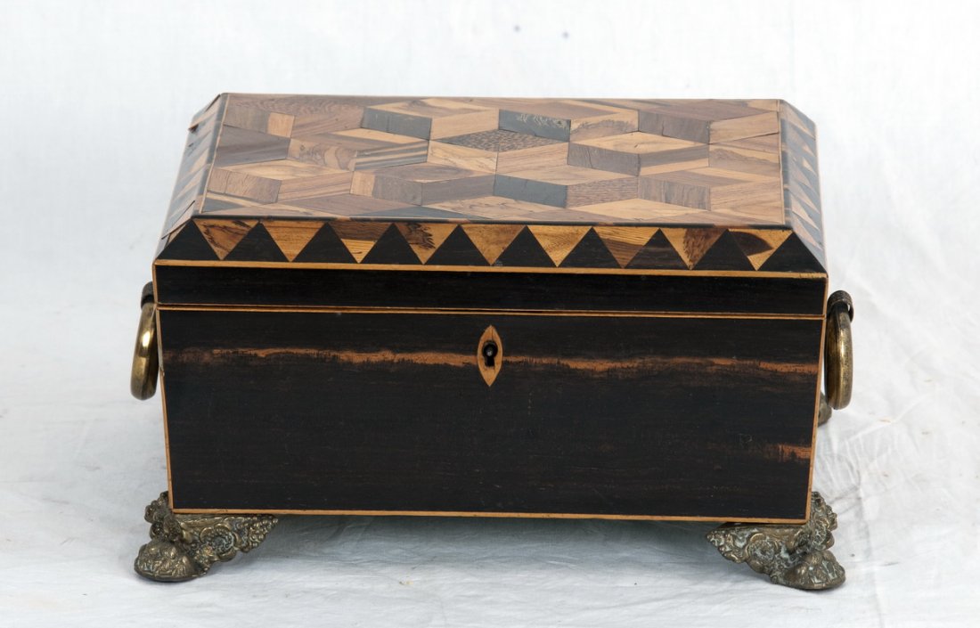 REGENCY STYLE PARQUETRY INLAID SEWING BOX: the rectangular box having a parquetry inlaid hinged lid with beveled edge, a pair of ring handles, and bronze paw feet; opening to a removable fitted compartment 10 3/4 inches long; 8 3/4 inches deep