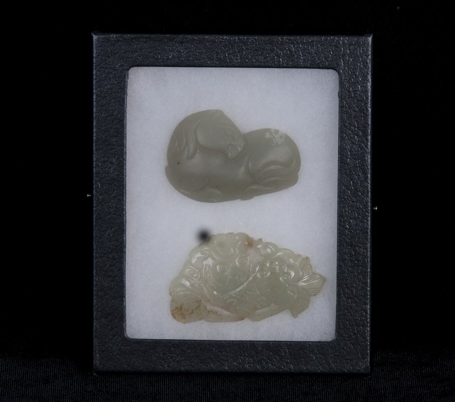 TWO HETIAN CARVED JADE BUCKLES: one in the form of a horse; the other, a lion the horse measuring 2 1/4 inches long; the lion, 2 5/8 inches long