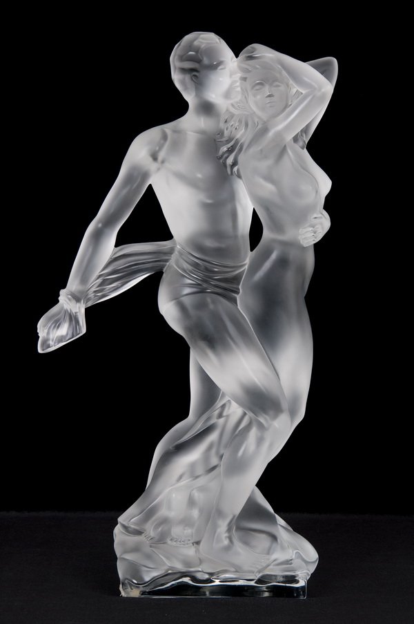 LALIQUE "PARADOX" MOLDED GLASS FIGURAL GROUP: the figures of a man and woman standing on a mound; signed "Lalique France" on base 9 1/2 inches wide; 19 1/2 inches high