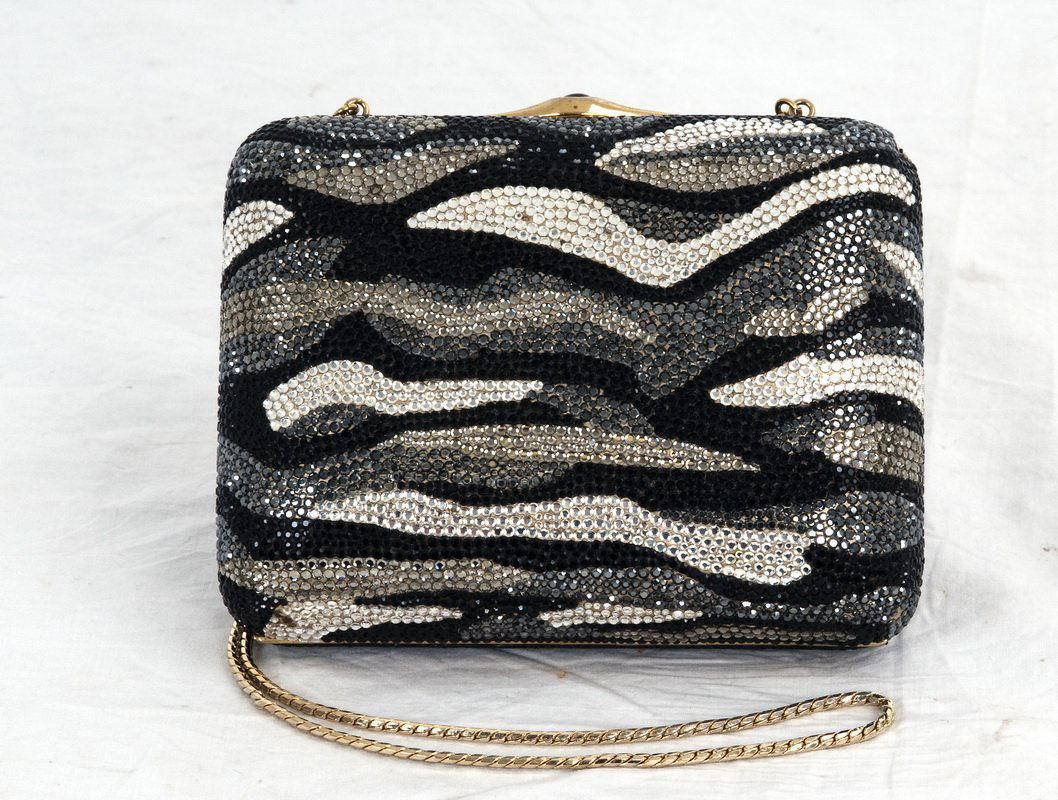 JUDITH LEIBER CRYSTAL MINAUDIERE: in black, silver, and gold tones with a long strap Provenance: The Estate of Bess Myerson Condition: with loss of sequins to corner 6 1/4 x 5 inches