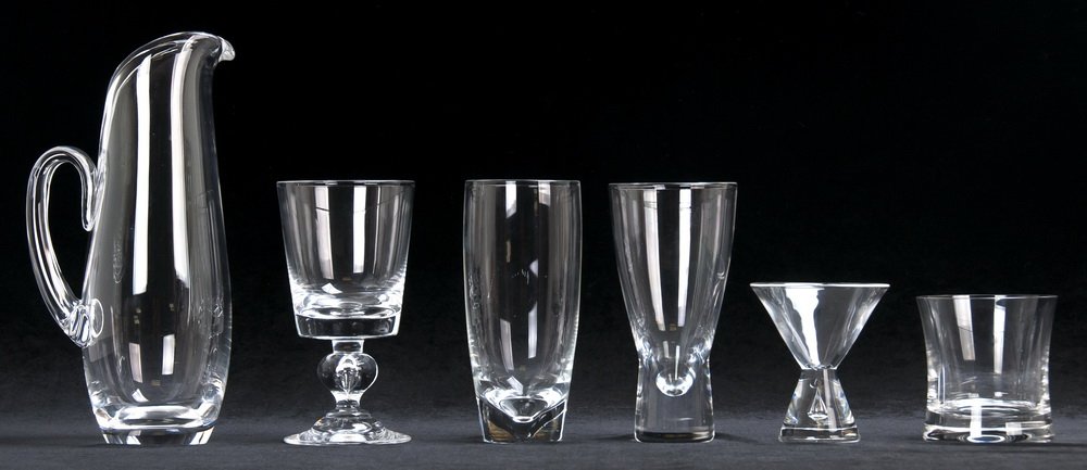 STEUBEN MOLDED GLASS PARTIAL BAR SERVICE: 38 pieces: pitcher, 7 martini glasses, 10 wine goblets, 3 highballs, 13 water glasses, 4 pilsner Provenance: the Estate of Sam Simon, benefiting the Sam Simon Charitable Giving Foundation