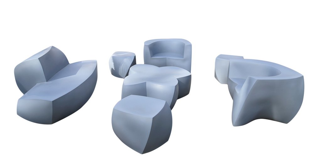 FRANK GEHRY FOR HELLER: SEVEN-PIECE OUTDOOR SEATING: molded plastic comprising two settees, an armchair, a coffee table, and three cubes molded underneath "Heller/The Frank Gehry Furniture Collection"