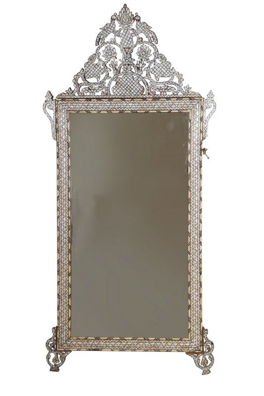 SYRIAN BONE & MOTHER OF PEARL INLAID MIRROR: the rectangular shaped mirror surmounted by a centered still life carving flanked by two facing birds inlaid with mother of pearl and bone throughout 80 1/2 x 38 inches