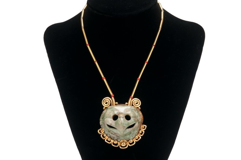WILLIAM SPRATLING 18 KARAT GOLD NECKLACE WITH: the nephrite jade pendant depicting a bird mask with a stylized frame; the clasp stamped 18K/WS Provenance: Estate of Millard Sheets approx. 15 1/2 inches