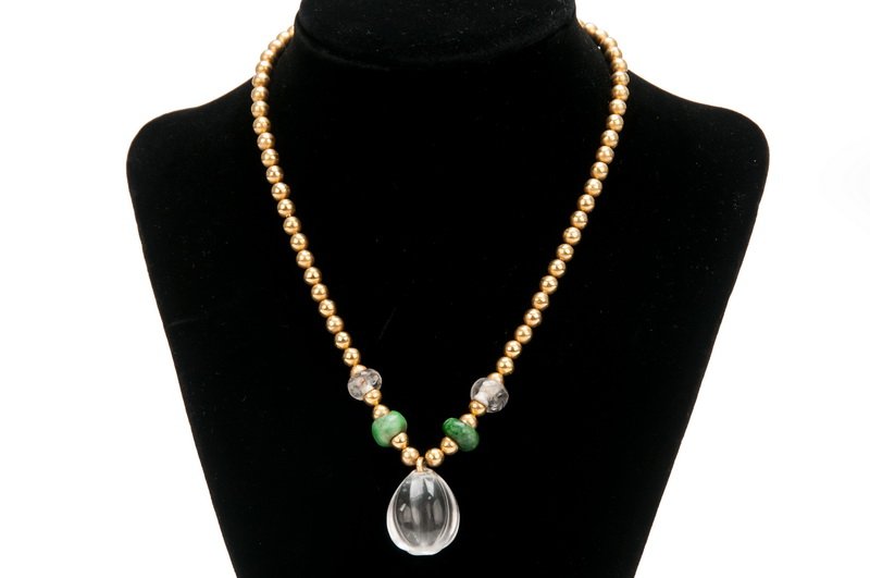 WILLIAM SPRATLING 18 KARAT BEADED GOLD & CRYSTAL: the rock crystal pendant on a beaded gold necklace with interspace rock crystal and nephrite discs Provenance: Estate of Millard Sheets 16 inches long