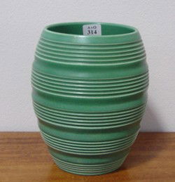 Keith Murray for Wedgwood: Ovoid mat green glazed vase incised with bands of concentric grooves. Printed KM mark to the base, H.170mm