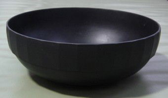 Keith Murray for Wedgwood black basalt bowl: With facet cut band to the upper section of the bowl. Incised Wedgwood factory mark, D.330mm