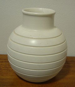 Keith Murray for Wedgwood spherical vase: With lathe turned incised concentric bands. Printed KM printed mark, H.150mm