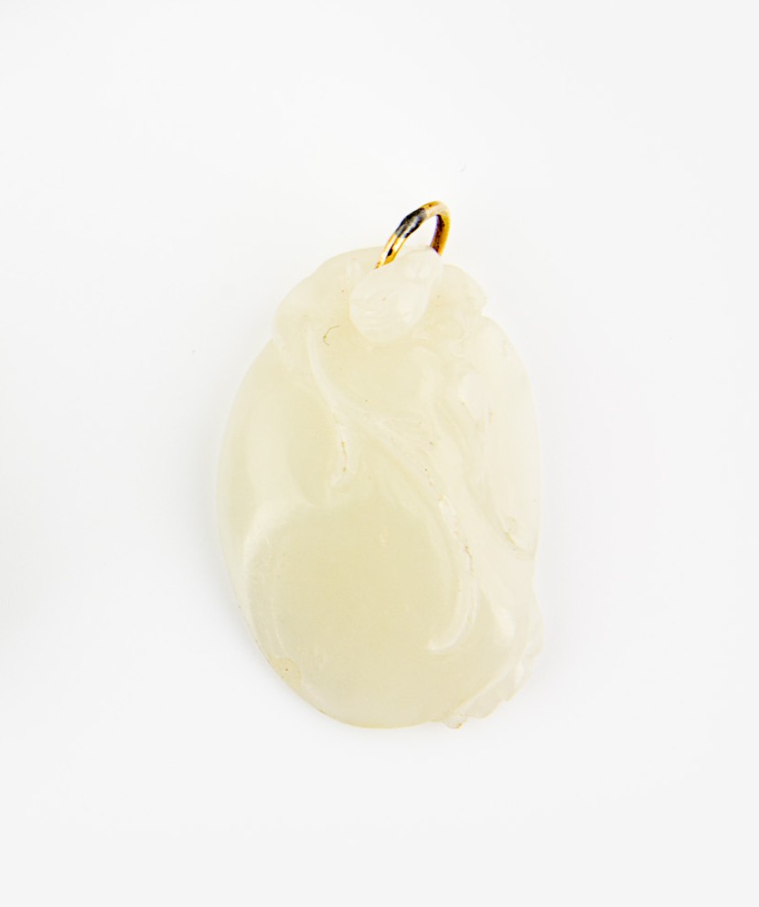 A white jade pendant: carved with a qilong dragon on a peach, the back carved with a bat and a flaming pearl, with gilt metal fitting H. 34mm Provenance: From the Leo Walker Tattersfield Collection of Chinese Jades