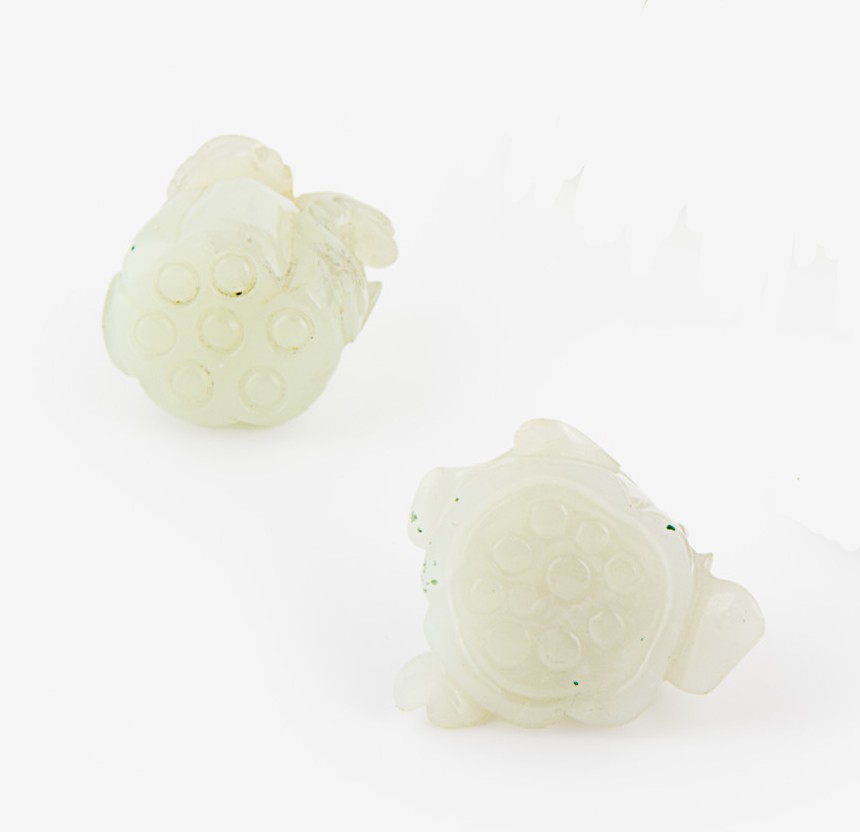 Two Chinese celadon jade lotus flower pendants: both carved with leaves H. 30mm Provenance: From the Leo Walker Tattersfield Collection of Chinese Jades