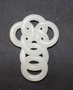 A white jade cross-shaped pendant: formed by intertwined rings H. 65mm Provenance: From the Leo Walker Tattersfield Collection of Chinese Jades