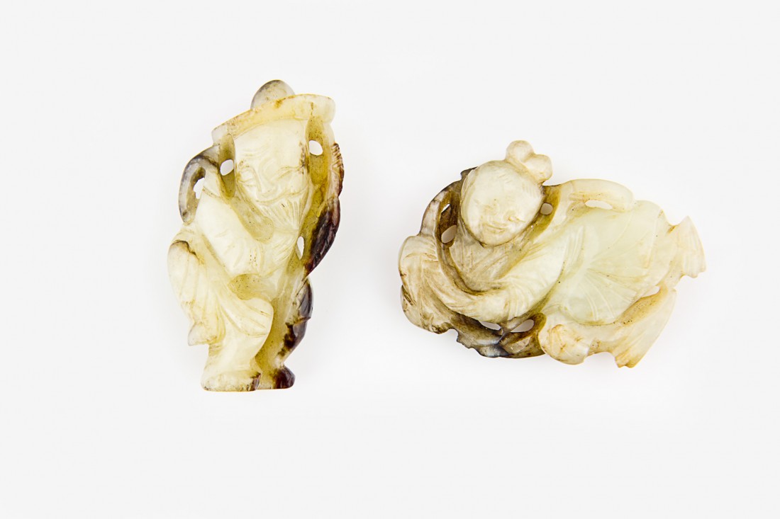 Two grey celadon and russet jade figural carvings: the first carved as an elder man with a hat, the second carved as a Flying Apsaras The first, H. 55mm Provenance: From the Leo Walker Tattersfield Collection of Chinese Jades