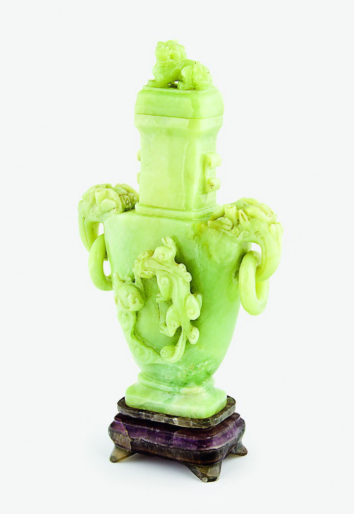 A large green jadeite handled vase and cover: the body carved with a qilong dragon chasing the flaming pearl, the cover with a Buddhistic lion, amethyst stand The vase, H. 290mm overall Provenance: From the Leo Walker Tattersfield Collection of C