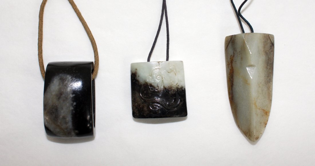 Chinese grey and black jade sword slide: a square celadon and black jade pendant carved with a chilong dragon and a grey celadon jade arrow-shaped pendant. The first, L. 35mm Provenance: From the Leo Walker Tattersfield Collection