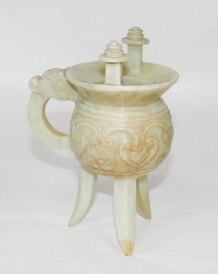 Chinese soapstone Jue ritual vessel: carved in archaistic style with a band of ruyi heads and dragon-head handle. H. 160mm Provenance: From the Leo Walker Tattersfield Collection