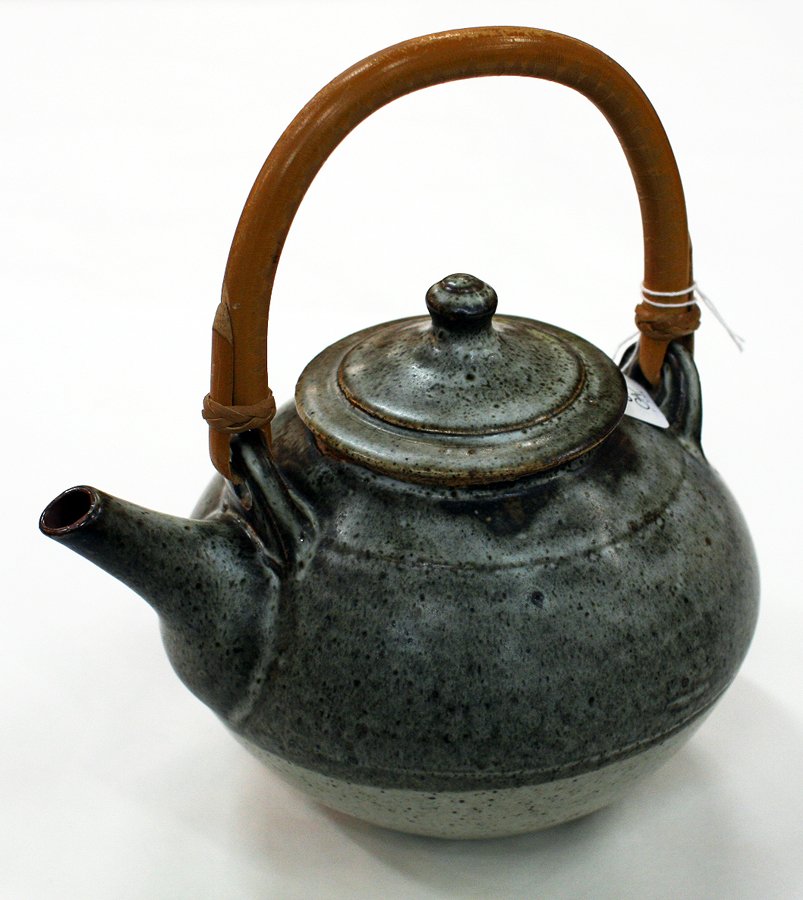 Len Castle: Stoneware teapot ash glazed with cane handle.
