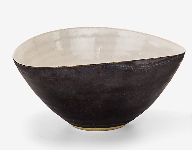 Lucie Rie: Elliptical shaped stoneware bowl, with white tin glaze to the interior and manganese glaze to the exterior, impressed LR seal mark to the base. D. 150mm Provenance: Beverley Luxton collection.