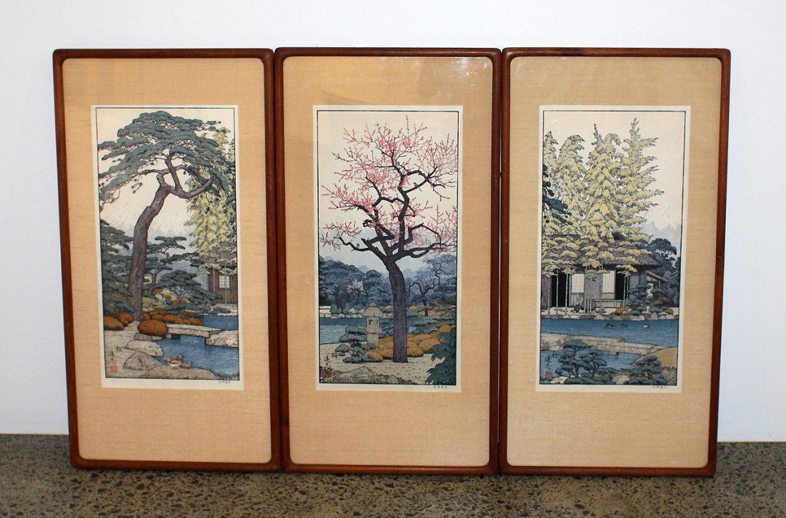 Toshi Yoshida: Three Japanese woodblock prints, of pines, bamboo and prunus in river landscapes. 500 x 245mm