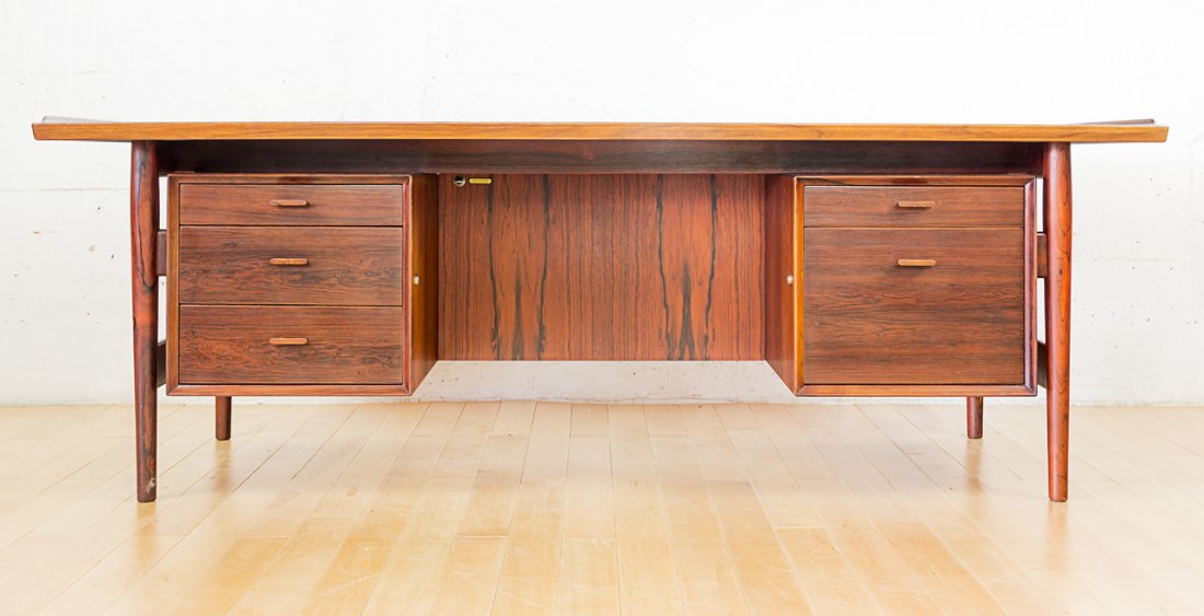 Arne Vodder for Sibast Mobler: Brazilian rosewood desk, with five drawers raised on tapering cylindrical legs. Maker's label affixed to the underside, circa 1960. W.2050mm x H.730mm x D.900mm