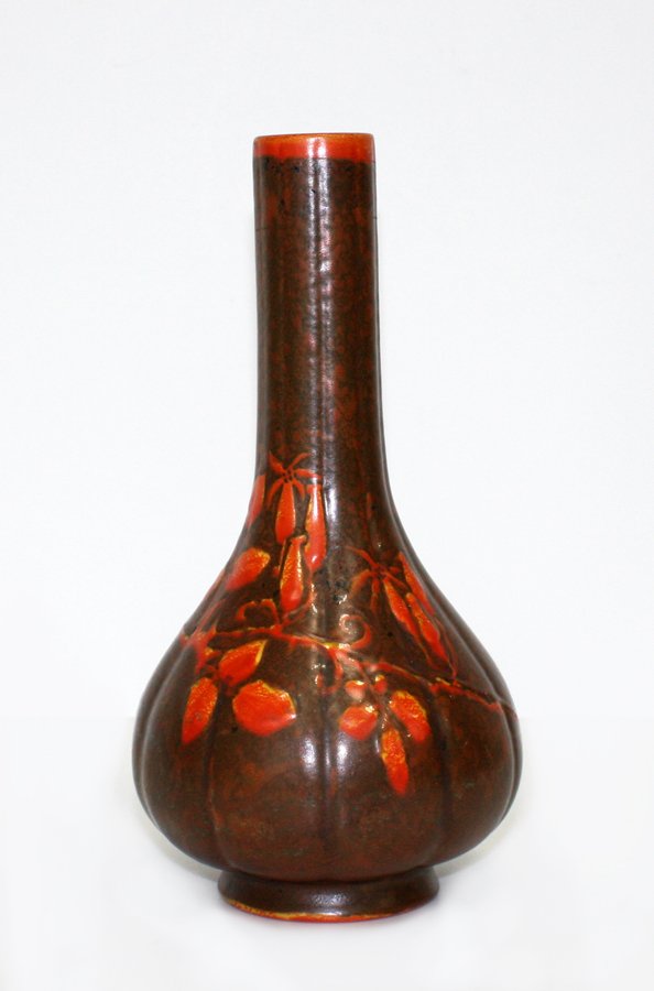 Pilkington's Royal Lancastrian bottle shaped vase: with leaves and rose hip decoration. H. 250mm
